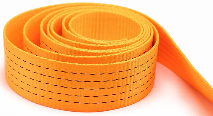 Orange polyester webbing roll shown complete with the free tail, finished edges and black tracer rows