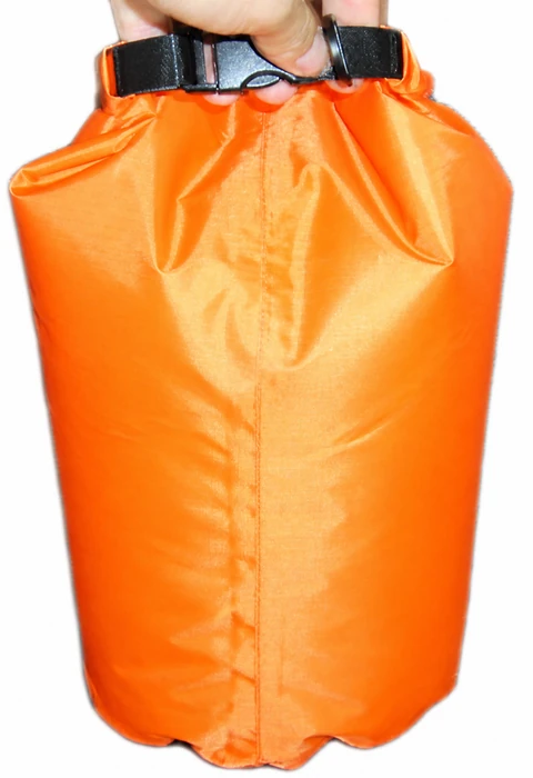 Complete orange dry bag handling view with hand, closed gathered mouth, black buckle and center seam