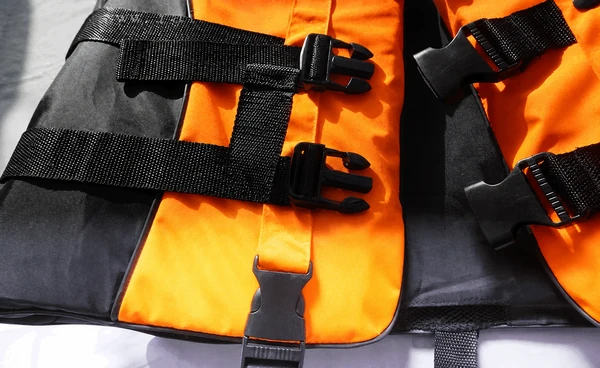 Life vest buckle engagement, webbing and strap-retainer detail