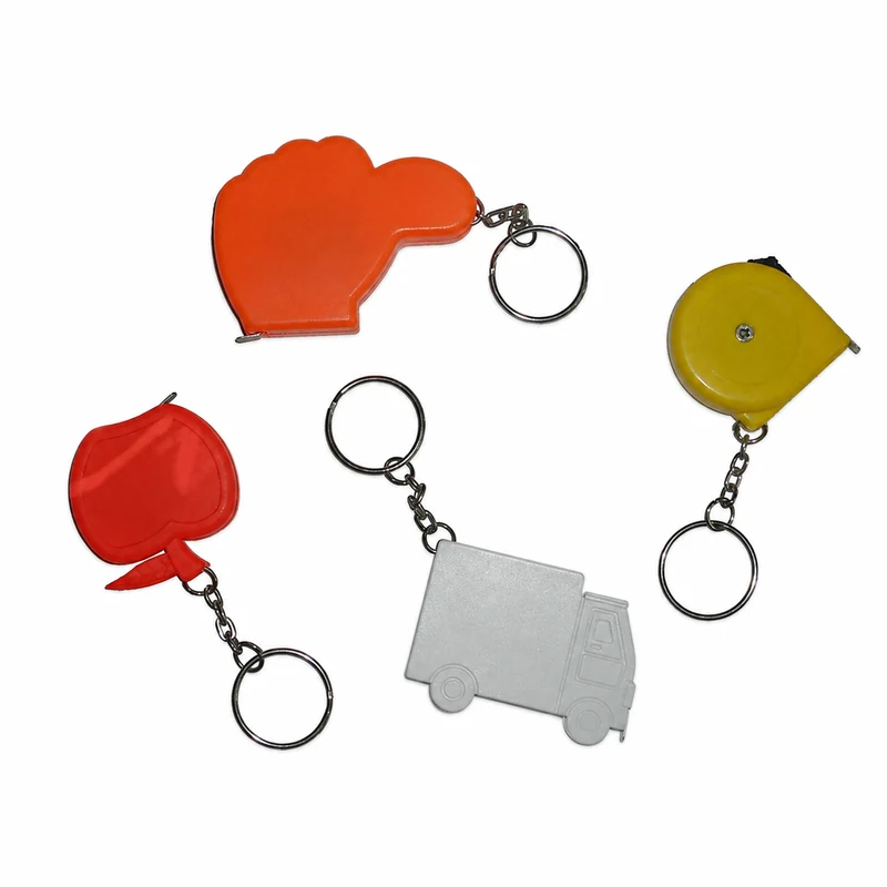 Complete novelty keychain tape measure housings with visible clips, rings, tape exits and decoration faces