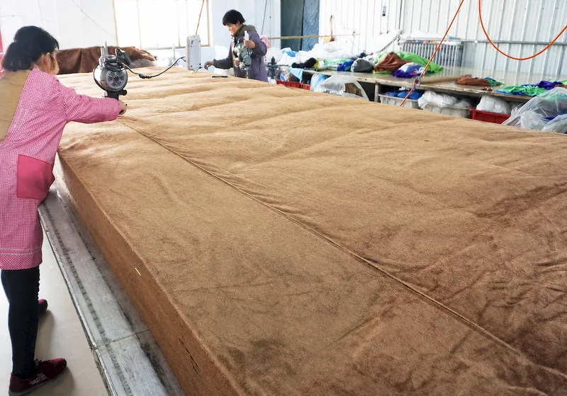 Layered microfiber fabric on a cutting table with cutting equipment