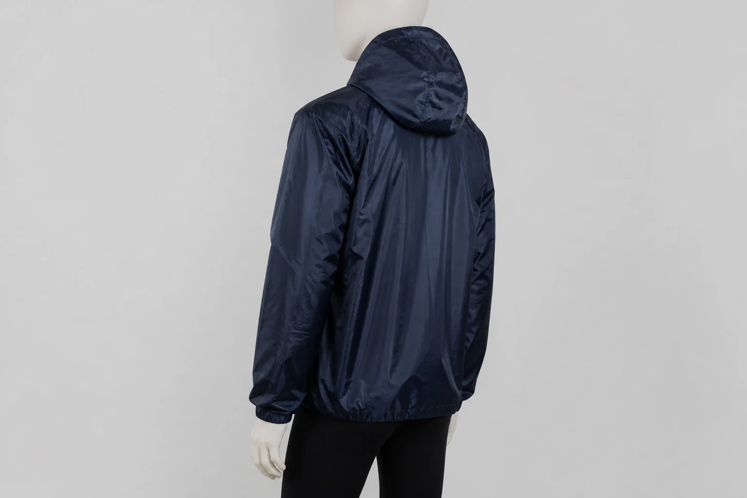 Complete dark navy coated polyester hooded jacket shown from the rear for construction review