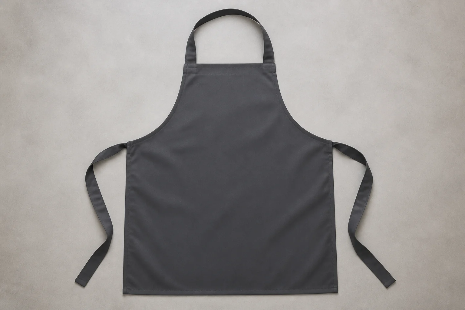 Complete charcoal bib apron with the full neck loop, front panel, pocket and side ties visible.